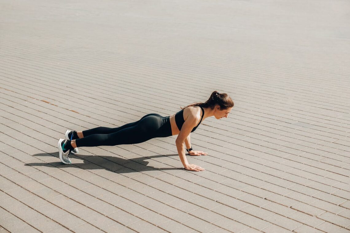 Woman in Black Tank Top and Black Leggings Doing Yoga