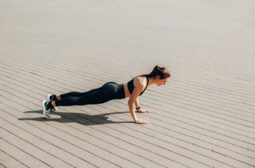 Woman in Black Tank Top and Black Leggings Doing Yoga